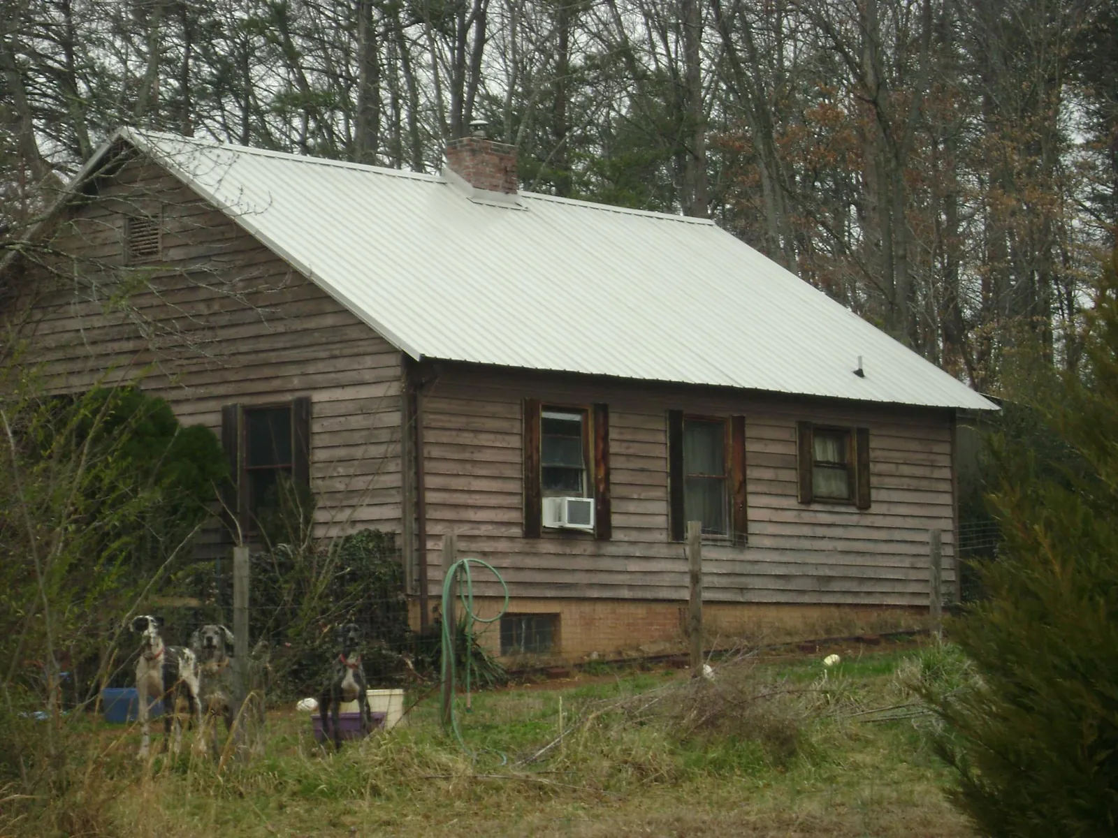 White metal roof on an old wood sided farmhouse, from a Metal Roof Installation job in Fiskeville